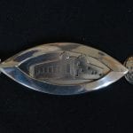 One part of the silver ceremonial chain of office for the Mayor. This one with the cabin, Rabothytta.