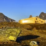 The cabin, Rabothytta, lit up by the sun and located right next to the glacier in Okstindan.