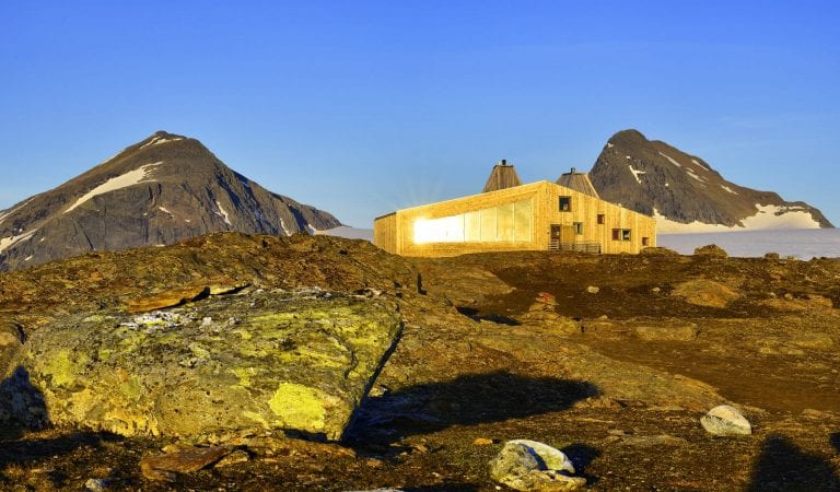 The cabin, Rabothytta, lit up by the sun and located right next to the glacier in Okstindan.