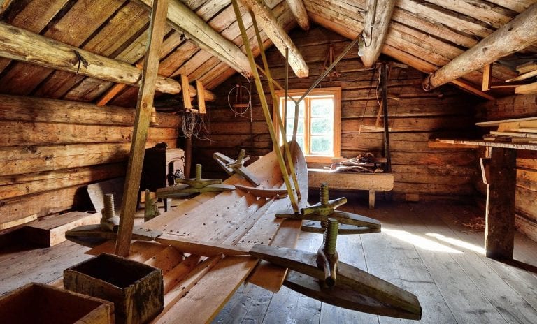 Building of boats made of wood inside an old wooden building.
