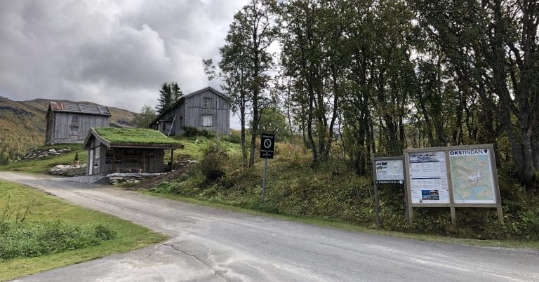 Entrance to Inderdalen Farm with signs and information about the Okstindan mountains.