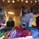 Happy, smiling “Okstind”-ladies at “Jul på Berget», a Christmas festival, selling their colorfully knitted products.