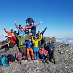 Lots of colorful and happy people celebrating being on top of Oksskolten, Norther-Norway’s highest mountain.