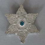 One of goldsmith, Merete Mattson’s silver jewelries in the shape of a star, called the Northern Rose Blue Star Topas.