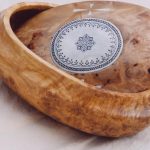 Wooden bowl with a lid, with decorations in bone and sami pictograms.