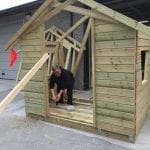 Worker at Hasvo in the process of building a house for a bus stop outside.